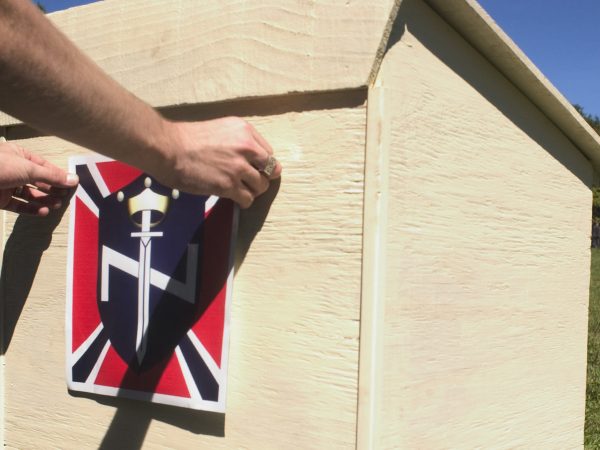 SCOTTSBORO, AL - SEPTEMBER 18: An Aryan Nations member puts the final touches on a the podium that will be used for speakers at the Aryan Nations sponsored White Heritage Days Festival September 18, 2004, which was held on private land near Scottsboro, Alabama. The event was originally scheduled as a pro-white family-friendly gathering, yet also served as an East Coast memorial to Pastor Richard G. Butler, the Aryan Nations founder who died about two weeks earlier at his home in Coure D'Alene, Idaho. The family-friendly event was attended by over 100 people, including members of Aryan Nations, White Revolution, the Ku Klux Klan and several independent, but racially conscious people. (Photo by David S. Holloway/Getty Images)
