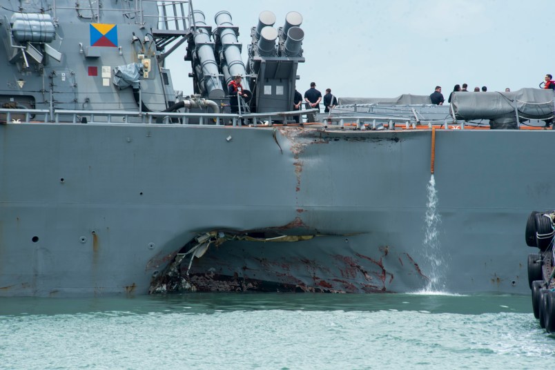 170821-N-OU129-022CHANGI NAVAL BASE, REPUBLIC OF SINGAPORE – Damage to the portside is visible as the Guided-missile destroyer USS John S. McCain (DDG 56) steers towards Changi Naval Base, Republic of Singapore, following a collision with the merchant vessel Alnic MC while underway east of the Straits of Malacca and Singapore on Aug. 21. Significant damage to the hull resulted in flooding to nearby compartments, including crew berthing, machinery, and communications rooms. Damage control efforts by the crew halted further flooding. The incident will be investigated. (U.S. Navy photo by Mass Communication Specialist 2nd Class Joshua Fulton/Released)