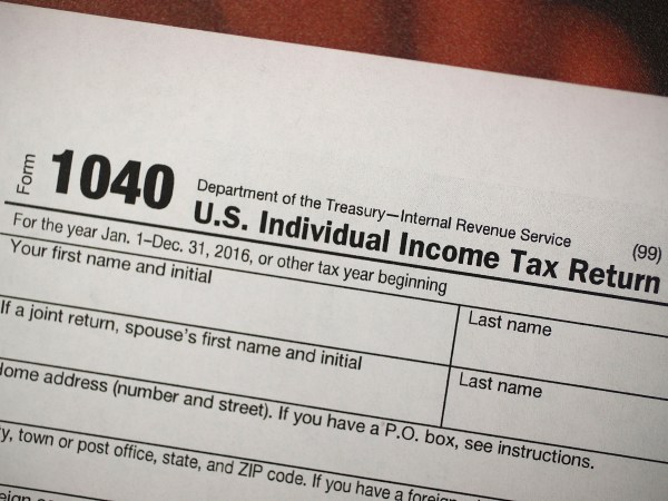 MIAMI, FL - DECEMBER 22:  A copy of a IRS 1040 tax form is seen at an H&R Block office on the day President Donald Trump signed the Republican tax cut bill in Washington, DC  on December 22, 2017 in Miami, Florida. Kathy Pickering, vice president of regulatory affairs and executive director of The Tax Institute at H&R Block released a statement about the new tax bill saying, " ItÕs going to change the way you think about and plan your income taxes. YouÕll need to take a fresh look at your individual situation to know your outcome and new strategies to use to get the best tax outcome.Ó  (Photo by Joe Raedle/Getty Images)