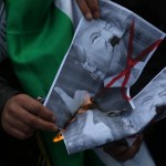 Palestinians burn posters depicting U.S. President Donald Trump and a U.S. flag and Israeli flag during a protest against Trump's decision to recognize Jerusalem as the capital of Israel, in Gaza City on January 15, 2018. (Photo by Majdi Fathi/NurPhoto)