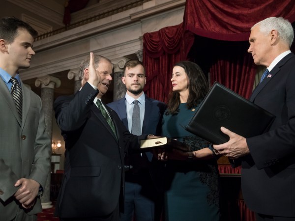 Doug Jones, second from left, the first Alabama Democrat elected to the Senate in a quarter century, is administered the oath of office by Vice President Mike Pence as his wife Louise holds the Bible, joined at far left by their son Christopher Jones, and son Carson Jones, center, during a ceremonial swearing-in at the Capitol in Washington, Wednesday, Jan. 3, 2018. Jones, 63, will represent one of the most conservative states in the nation and is stressing his desire to work with both parties. Jones defeated Republican Roy Moore in a special election to take the seat once held by Attorney General Jeff Sessions. (AP Photo/J. Scott Applewhite)