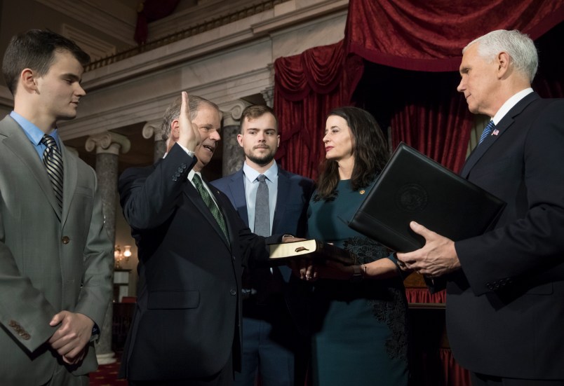 Doug Jones, second from left, the first Alabama Democrat elected to the Senate in a quarter century, is administered the oath of office by Vice President Mike Pence as his wife Louise holds the Bible, joined at far left by their son Christopher Jones, and son Carson Jones, center, during a ceremonial swearing-in at the Capitol in Washington, Wednesday, Jan. 3, 2018. Jones, 63, will represent one of the most conservative states in the nation and is stressing his desire to work with both parties. Jones defeated Republican Roy Moore in a special election to take the seat once held by Attorney General Jeff Sessions. (AP Photo/J. Scott Applewhite)