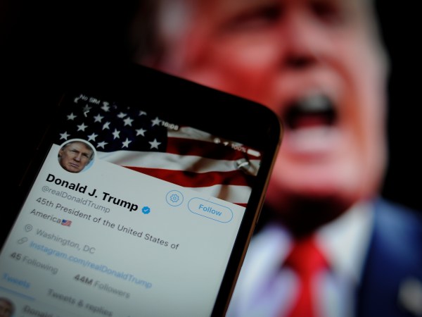 The Twitter app is seen with an image of US president Donald Trump in the background in this photo illustration on December 4, 2017. (Photo by Jaap Arriens/NurPhoto)