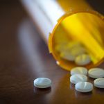 CANADA - 2016/01/21: Prescription pills in a yellow bottle over a wooden table with selective depth of field. (Photo by Roberto Machado Noa/LightRocket via Getty Images)