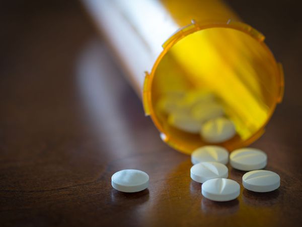 CANADA - 2016/01/21: Prescription pills in a yellow bottle over a wooden table with selective depth of field. (Photo by Roberto Machado Noa/LightRocket via Getty Images)