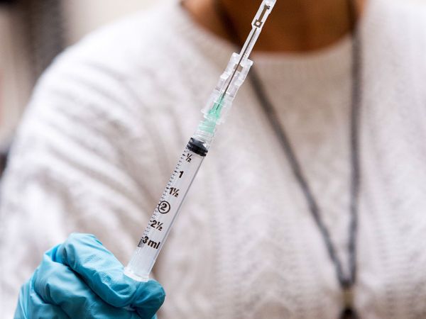 BETHESDA, MD - NOVEMBER 21: Nurse Floreliz Mendoza holds the syringe she has used to inject Andie Vaught, 25, with an experimental Zika vaccine as part of a clinical trial at the National Institute of Health Clinical Center in Bethesda, Maryland, November 21, 2016. This vaccine, one of about six or seven in different phases of clinical trial, is currently undergoing safety testing at three locations in the country. Instead of using dead or weakened virus to get the immune system to recognize the infection and fight it off, it uses a piece of DNA engineered to contain genes that code for proteins of the Zika virus. (Photo by Allison Shelley/For The Washington Post)