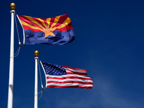 CANYON DE CHELLY, AZ - MARCH 18, 2017:  The Arizona state flag flies beside the United States flag at the Visitor Center at Canyon de Chelly National Monument near Chinle, Arizona. Established in 1931, the monument is jointly managed by the National Park Service and the Navajo Nation. The monument is entirely on Navajo tribal lands in northeastern Arizona. (Photo by Robert Alexander/Getty Images)