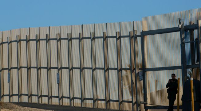 SAN YSIDRO, CA-FEB 7: A border patrol officer stands guard along the U.S.-Mexico border on Wednesday, February 7, 2018 in San Ysidro, California.  The rally coincides on the eve of Congress's spending bill deadline and is urging lawmakers to pass a clean Dream Act without provisions for a border wall.(Photo by Sandy Huffaker/Getty Images)