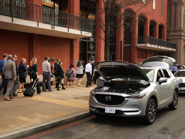 A suspicious vehicle stands with its doors, hood and tailgate open after being inspected in front of the New Executive Office Building, tying up rush hour traffic for blocks near the White House, February 21, 2018 in Washington, DC. The vehicle was later declared safe.