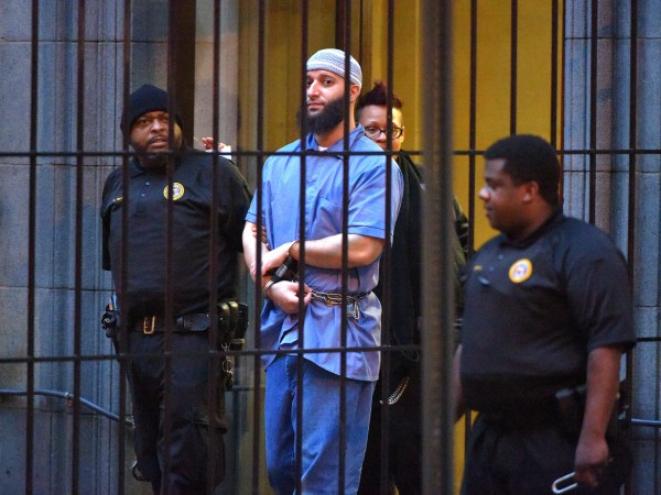 Officials escort "Serial" podcast subject Adnan Syed from the courthouse following the completion of the first day of hearings for a retrial in Baltimore on Wednesday, Feb. 3, 2016. (Karl Merton Ferron/Baltimore Sun/TNS)