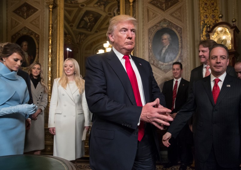 President Donald Trump leaves the President’s Room of the Senate at the Capitol after he formally signed his cabinet nominations into law, in Washington, Friday, Jan. 20, 2017. He is joined by his wife Melania Trump and  and daughter Tiffany Trump. At far right is Chief of Staff Reince Priebus, with White House counsel Donald McGahn, second from right. (AP Photo/J. Scott Applewhite, Pool)