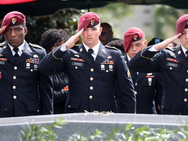 Members of the 3rd Special Forces Group Airborne 2nd Battalion leave pins and salute the casket after the burial of Army Sgt. La David Johnson at Fred Hunter's Hollywood Memorial Gardens in Hollywood, Fla., on Saturday, Oct. 21, 2017. (Mike Stocker/Sun Sentinel/TNS)