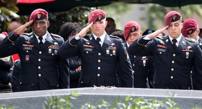 Members of the 3rd Special Forces Group Airborne 2nd Battalion leave pins and salute the casket after the burial of Army Sgt. La David Johnson at Fred Hunter's Hollywood Memorial Gardens in Hollywood, Fla., on Saturday, Oct. 21, 2017. (Mike Stocker/Sun Sentinel/TNS)