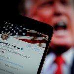 The Twitter app is seen with an image of US president Donald Trump in the background in this photo illustration on December 4, 2017. (Photo by Jaap Arriens/NurPhoto)