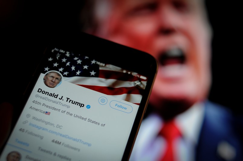 The Twitter app is seen with an image of US president Donald Trump in the background in this photo illustration on December 4, 2017. (Photo by Jaap Arriens/NurPhoto)