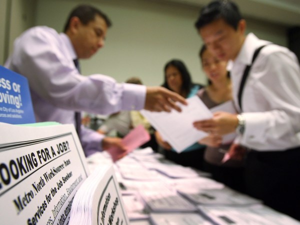 PASADENA, CA - MAY 14:  Job seekers look over job opening fliers at the WorkSource exhibit, a collaborative effort by governmental agencies to offer jobs and job training resources at the Greater Los Angeles Career Expo at the Pasadena Convention Center on May 14, 2009 in Pasadena, California. Nineteen exhibitors offer job and educational opportunities as well as advice from the Board of Equalization at the event that is open to the general public.  (Photo by David McNew/Getty Images)