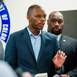FILE - In this June 5, 2017, file photo, Arizona state Democratic Rep. Reginald Bolding Jr., left, calls on Gov. Doug Ducey to remove six confederate monuments in Arizona during a news conference by the NAACP and Black Lives Matter in Phoenix, Ariz. Bolden successfully pushed for changes in the state's driving rules that inform gun-carrying motorists how they should handle themselves if they get pulled over by police officers. (AP Photo/Angie Wang, File)