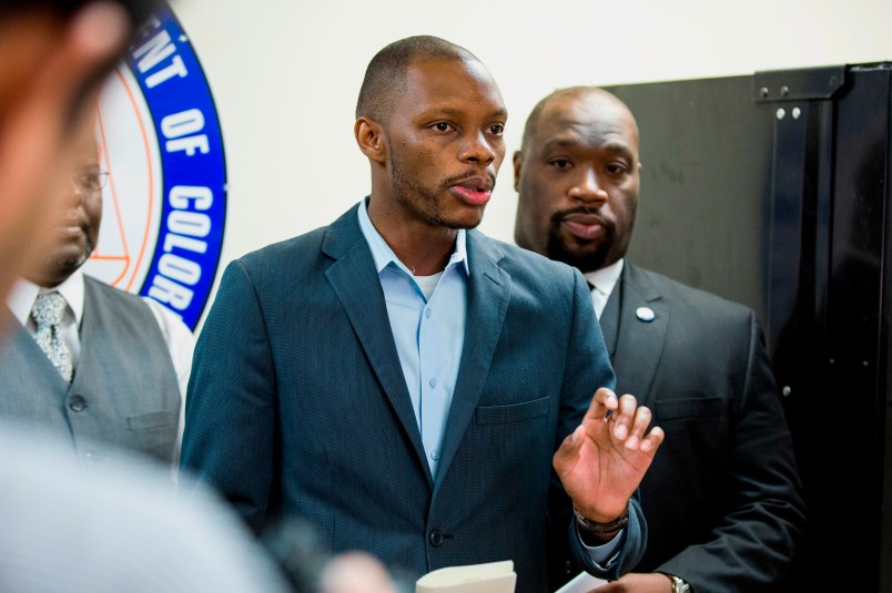 FILE - In this June 5, 2017, file photo, Arizona state Democratic Rep. Reginald Bolding Jr., left, calls on Gov. Doug Ducey to remove six confederate monuments in Arizona during a news conference by the NAACP and Black Lives Matter in Phoenix, Ariz. Bolden successfully pushed for changes in the state's driving rules that inform gun-carrying motorists how they should handle themselves if they get pulled over by police officers. (AP Photo/Angie Wang, File)