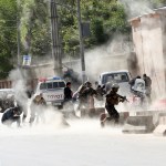 Security forces run from the site of a suicide attack one frame after the second deadly attack in Kabul, Afghanistan, Monday, April 30, 2018.  (AP Photo/Massoud Hossaini)