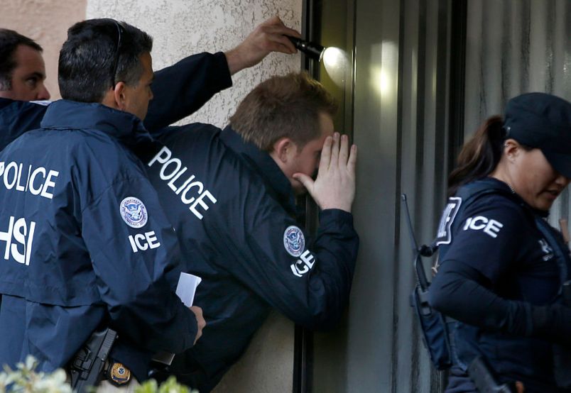 ROWLAND HEIGHTS, CA. - MARCH 3: Immigration and Customs Enforcement (ICE) agents from the Department of Homeland Security look into the window of an apartment while executing search warrants during an ongoing investigation of alleged birth tourism centers on March 3, 2015 in Rowland Heights, California. Agents from multiple federal and local law enforcement agencies executed search warrants in Orange, Los Angeles and San Bernardino counties on Tuesday morning. (Photo by Mark Boster/Los Angeles Times via Getty Images)