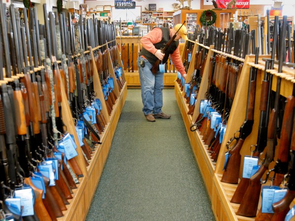 Gregory Rec/Staff Photographer...Don Parizo of Vermont looks over hunting rifles at Kittery Trading Post in Kittery on Wednesday, November 19, 2008.