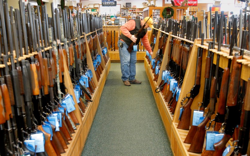 Gregory Rec/Staff Photographer...Don Parizo of Vermont looks over hunting rifles at Kittery Trading Post in Kittery on Wednesday, November 19, 2008.