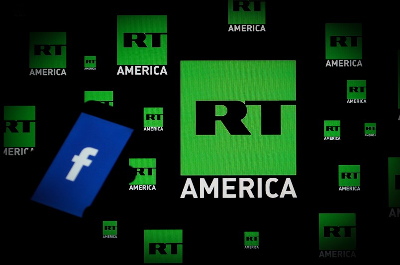 A Facebook logo is seen on a portable device with the logo of Russia Today (RT) news channel in the background in this photo illustration on November 15, 2017. (Photo by Jaap Arriens/NurPhoto)