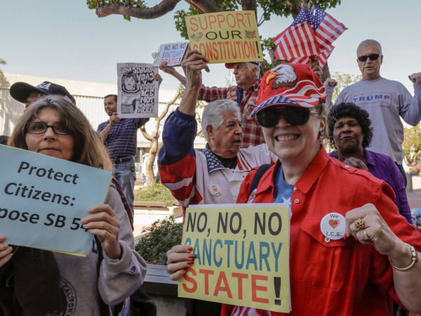 SANTA ANA CA MARCH 27, 2018 --- People opposing SB-54 celebrate. The Orange County Board of Supervisors approved a resolution to condemn the state's sanctuary laws. They also voted to join the Feds in their lawsuit against State of California. (Irfan Khan / Los Angeles Times)