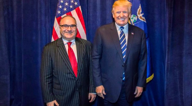 **HOLD FOR STORY TO MOVE OVERNIGHT. WDC WILL ADVISE TIMING** This photo acquired by The Associated Press is copied from a leaked email sent by Elliott Broidy and shows George Nader posing for a photo with President Donald Trump back stage at an RNC fund raiser in Dallas on Oct. 25, 2017. (AP Photo)