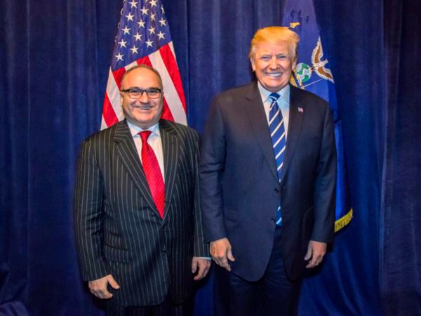 **HOLD FOR STORY TO MOVE OVERNIGHT. WDC WILL ADVISE TIMING** This photo acquired by The Associated Press is copied from a leaked email sent by Elliott Broidy and shows George Nader posing for a photo with President Donald Trump back stage at an RNC fund raiser in Dallas on Oct. 25, 2017. (AP Photo)