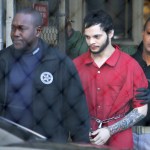 FILE - In this Jan. 30, 2017, file photo, Esteban Santiago, center, is led from the Broward County jail for an arraignment in federal court in Fort Lauderdale, Fla. Court records say Santiago charged with killing five people and wounding six in a shooting rampage at a Florida airport has been found mentally competent and is scheduled to plead guilty later in May 2018. Federal prosecutors said in a court filing late Monday, Monday, May 14, 2018, that Santiago was recently evaluated by a psychologist. (AP Photo/Lynne Sladky, File)