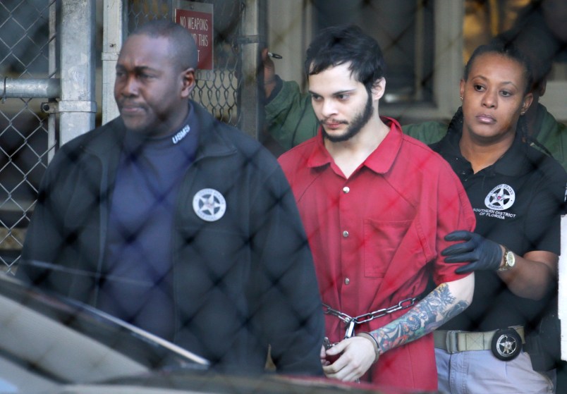 FILE - In this Jan. 30, 2017, file photo, Esteban Santiago, center, is led from the Broward County jail for an arraignment in federal court in Fort Lauderdale, Fla. Court records say Santiago charged with killing five people and wounding six in a shooting rampage at a Florida airport has been found mentally competent and is scheduled to plead guilty later in May 2018. Federal prosecutors said in a court filing late Monday, Monday, May 14, 2018, that Santiago was recently evaluated by a psychologist. (AP Photo/Lynne Sladky, File)