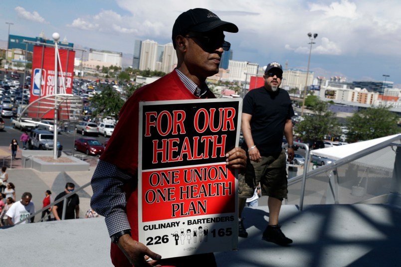 Culinary Union members file into a university arena to vote on whether to authorize a strike Tuesday, May 22, 2018, in Las Vegas. (AP Photo/Isaac Brekken)