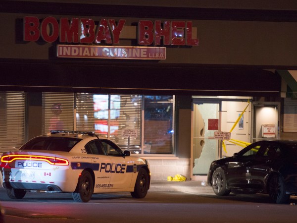 Police stand outside the Bombay Bhel restaurant in Mississauga, Ont. on Friday May 25, 2018. Fifteen people were injured Thursday night when an explosion police say was caused by an "improvised explosive device" ripped through a restaurant in Mississauga. Ontario. THE CANADIAN PRESS/Doug Ives