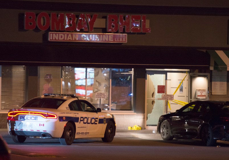 Police stand outside the Bombay Bhel restaurant in Mississauga, Ont. on Friday May 25, 2018. Fifteen people were injured Thursday night when an explosion police say was caused by an "improvised explosive device" ripped through a restaurant in Mississauga. Ontario. THE CANADIAN PRESS/Doug Ives
