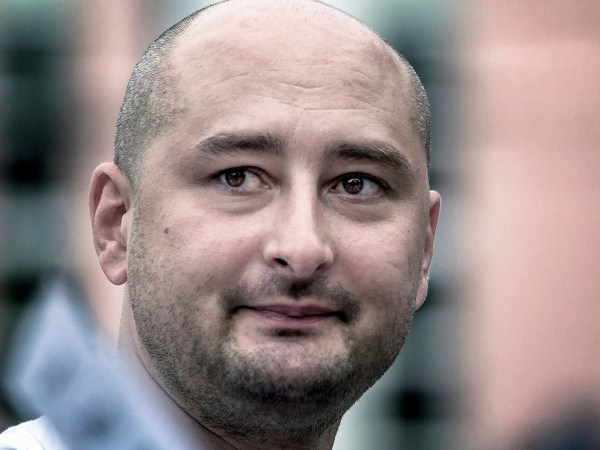 In this photo taken on Friday, Aug. 9, 2013, Arkady Babchenko, 41, who had been scathingly critical of the Kremlin in recent years, looks at an opposition picket in Moscow, Russia. Police in the capital of Ukraine say a Russian journalist has been shot and killed at his Kiev apartment. Ukrainian police said Arkady Babchenko’s wife found him bleeding at the apartment on Tuesday and called an ambulance, but Babchenko died on the way to a hospital. (AP Photo/Alexander Baroshin)