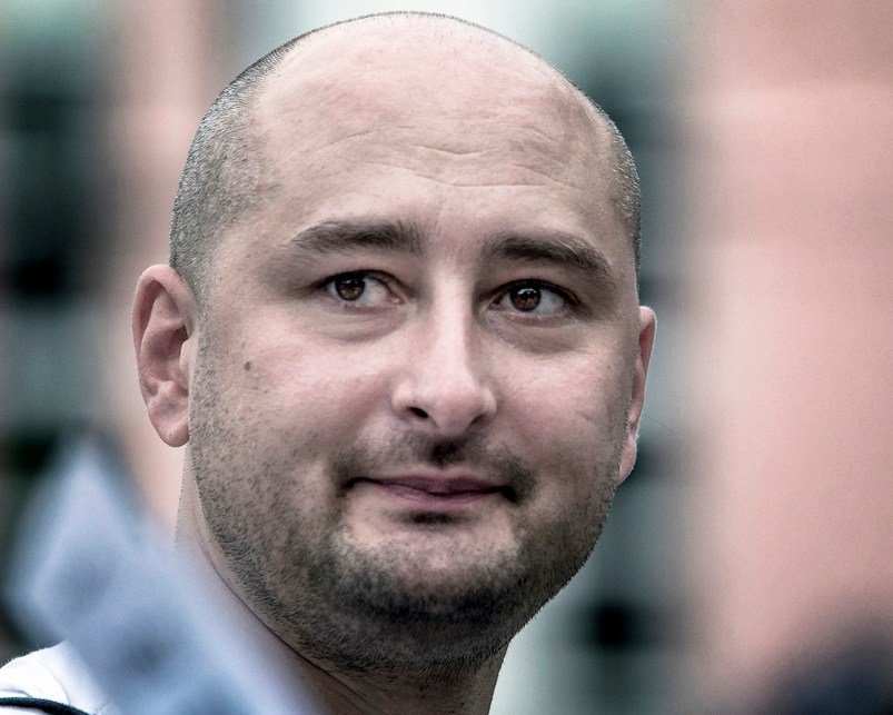 In this photo taken on Friday, Aug. 9, 2013, Arkady Babchenko, 41, who had been scathingly critical of the Kremlin in recent years, looks at an opposition picket in Moscow, Russia. Police in the capital of Ukraine say a Russian journalist has been shot and killed at his Kiev apartment. Ukrainian police said Arkady Babchenko’s wife found him bleeding at the apartment on Tuesday and called an ambulance, but Babchenko died on the way to a hospital. (AP Photo/Alexander Baroshin)
