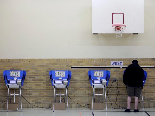 Bowling Green, OH  - NOVEMBER 6: A man casts his ballot using an electronic voting machine November 6, 2012 at an elementary school in Bowling Green, Ohio. Voting is underway in the US presidential election in the battleground state of Ohio. (Photo by J.D. Pooley/Getty Images)