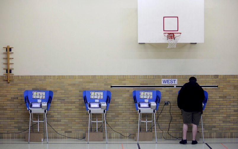 Bowling Green, OH  - NOVEMBER 6: A man casts his ballot using an electronic voting machine November 6, 2012 at an elementary school in Bowling Green, Ohio. Voting is underway in the US presidential election in the battleground state of Ohio. (Photo by J.D. Pooley/Getty Images)