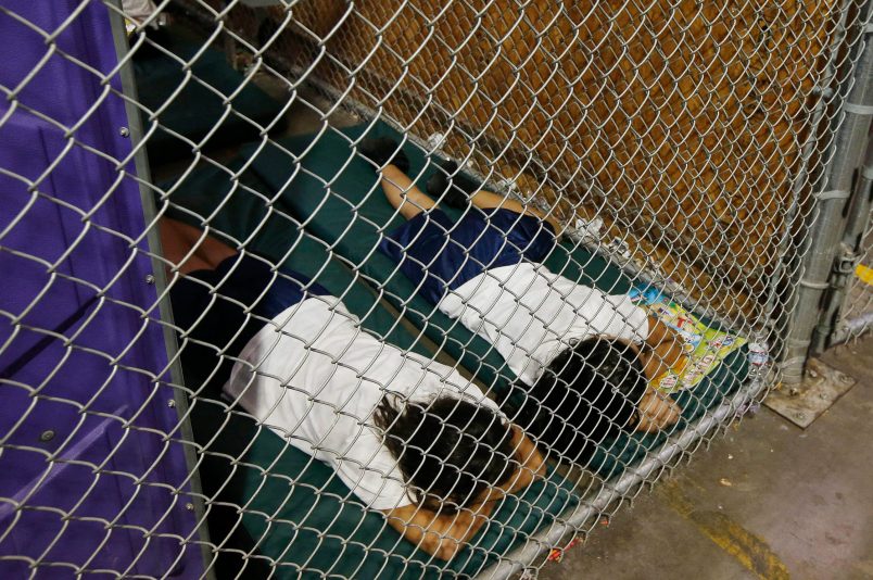 Two female detainees sleep in a holding cell, as the children are separated by age group and gender, as hundreds of mostly Central American immigrant children are being processed and held at the U.S. Customs and Border Protection Nogales Placement Center on Wednesday, June 18, 2014, in Nogales, Ariz.  CPB provided media tours Wednesday of two locations in Brownsville, Texas, and Nogales, that have been central to processing the more than 47,000 unaccompanied children who have entered the country illegally since Oct. 1. (AP Photo/Ross D. Franklin, Pool)