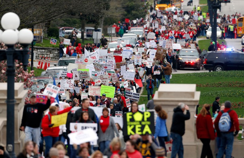 Thousands of Kentucky school teachers marched Monday, April 2, 2018 from the Kentucky Education Association's headquarters to the State Capitol in Frankfort, Ky. to protest legislative changes to their pensions and education cuts. Public schools in all 120 Kentucky counties were closed Monday, either to join in the protest or because of spring break. (Charles Bertram/Lexington Herald-Leader/TNS)