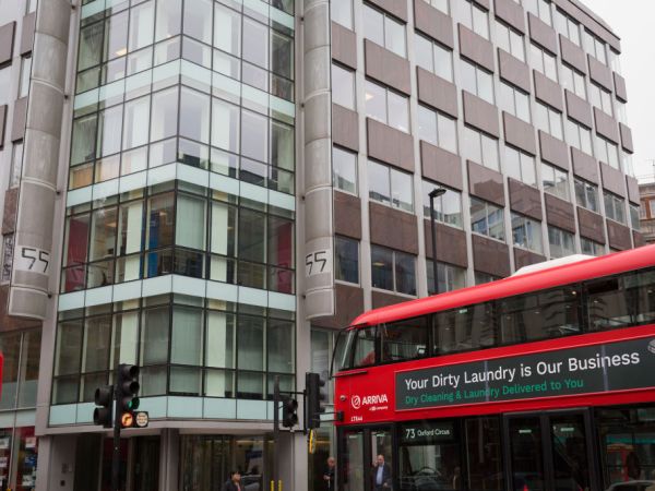 A London bus with an ad for dirty washing drives past the offices of Cambridge Analytica on New Oxford Street, the UK tech company accused of harvesting the personal details of Facebook users in its data privacy scandal, on 11th April, 2018, in London, England. (Photo by Richard Baker / In Pictures via Getty Images)