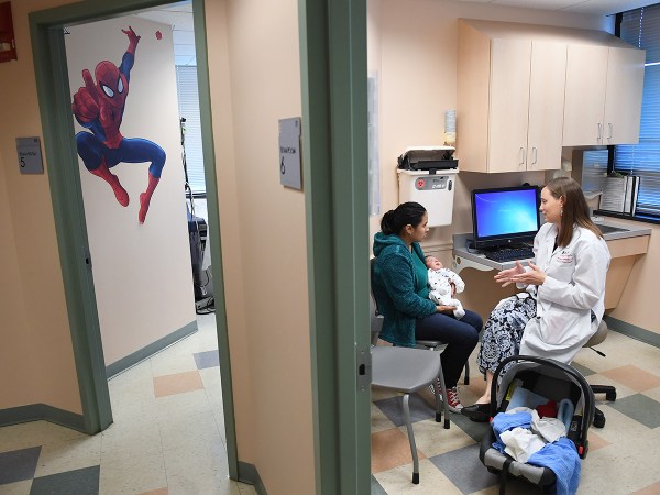 FALLS CHURCH, VA - OCTOBER 31: Ana Elsy Ramirez Diaz holds her son, Milan Rojas Ramirez as he is seen by Dr. Margaret-Anne Fernandez during a check-up visit at INOVA Cares Clinic for Children on Tuesday October 31, 2017 in Falls Church. A portion of the clinic's patients are insured through the Children's Health Insurance Program. (Photo by Matt McClain/The Washington Post via Getty Images)