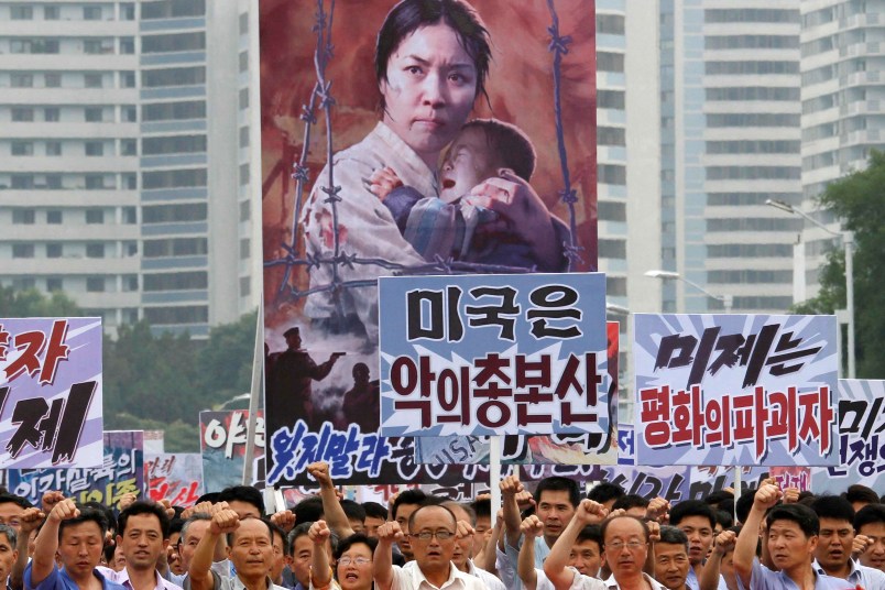 Tens of thousands of men and women pump their fists in the air and chant as they carry placards with anti-American propaganda slogans at Pyongyang's central Kim Il Sung Square on Sunday, June 25, 2017, in North Korea, to mark what North Korea calls "the day of struggle against U.S. imperialism" – the anniversary of the start of the Korean War. (AP Photo/Jon Chol Jin)