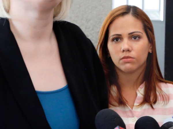 Lidia Karine Souza watches as one of her attorneys speaks outside U.S. District Court in Chicago on Thursday, June 28, 2018. Souza, who is from Brazil, and her son, Diogo, entered the United States in New Mexico in late May and were separated a few days later. The boy has been in a Chicago shelter for about a month. An asylum-seeker due to dangers that Souza says they face in Brazil, she is fighting to get her son back. A judge heard arguments Thursday and said he would issue a ruling soon. (AP Photo/Martha Irvine)