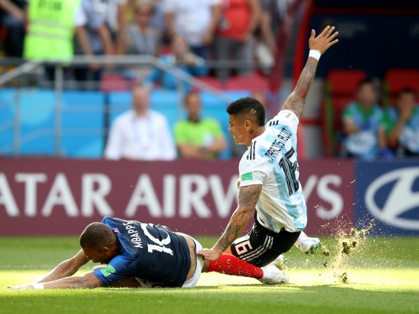 France's Kylian Mbappe, left, is fouled by Argentina's Marcos Rojo, drawing a penalty, during the round of 16 match between France and Argentina, at the 2018 soccer World Cup at the Kazan Arena in Kazan, Russia, Saturday, June 30, 2018. (AP Photo/Thanassis Stavrakis)