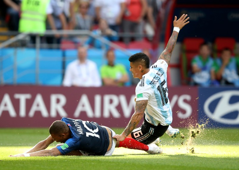 France's Kylian Mbappe, left, is fouled by Argentina's Marcos Rojo, drawing a penalty, during the round of 16 match between France and Argentina, at the 2018 soccer World Cup at the Kazan Arena in Kazan, Russia, Saturday, June 30, 2018. (AP Photo/Thanassis Stavrakis)