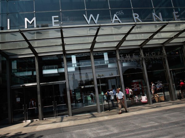 NEW YORK - AUGUST 06:  People walk near the Time Warner Center August 6, 2008 in New York City.  Time Warner announced a second quarter profit drop of 26 percent on lower earnings mostly attributed to the AOL Internet unit, but beat Wall Streets expectations, The media comglomerate is reportedly considering breaking off its AOL divisions.  (Photo by Chris Hondros/Getty Images)
