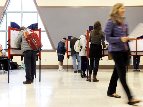PORTLAND, ME - NOVEMBER 7: Sue Vittner, right, walks her completed ballot to the scanning booth at the Merrill Auditorium voting station Tuesday morning. Turnout at the station has been “pretty good,” according to Election Warden Carol . By 8:20 a.m., the site had processed ballots from 95 voters, which Morrissette estimated was already three times as many voters who cast ballots at the same station during the May election. (Staff photo by Ben McCanna/Staff Photographer)