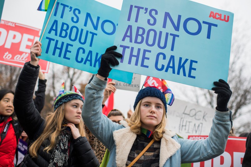 UNITED STATES - DECEMBER 05: Lydia Macy, right, of Berkeley, Calif., siding with a same-sex couple, holds a sign outside Supreme Court where arguments were being on heard on whether a Colorado baker, who refused to make a wedding cake for the couple based on his religious beliefs, is protected by the First Amendment on December 5, 2017. (Photo By Tom Williams/CQ Roll Call)